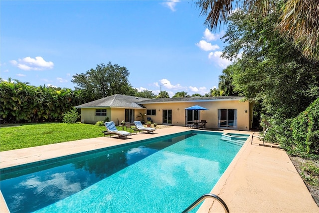 view of pool featuring a patio area, a yard, and french doors