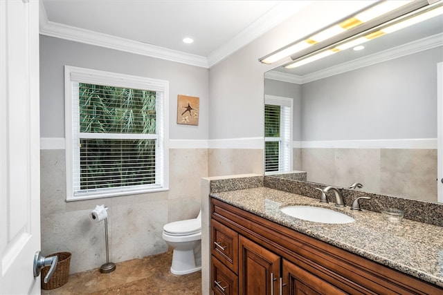 bathroom with crown molding, a healthy amount of sunlight, and tile walls