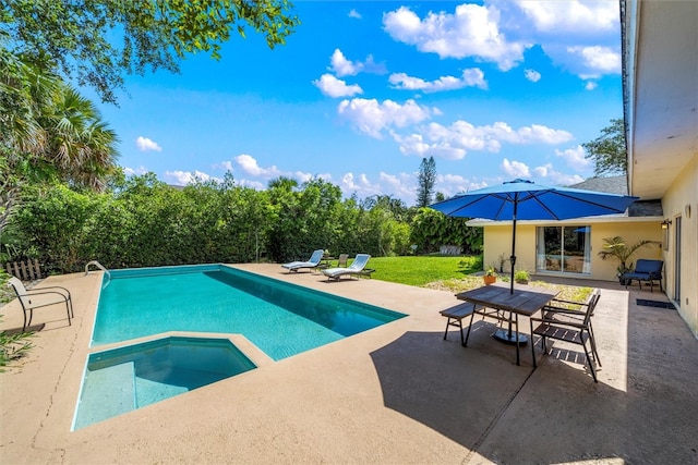 view of pool featuring a patio and an in ground hot tub