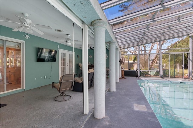 pool with a patio, french doors, glass enclosure, and ceiling fan
