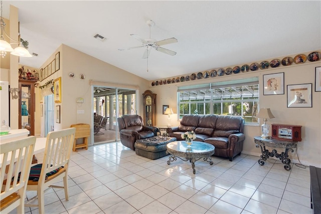 living area with light tile patterned flooring, visible vents, a ceiling fan, and lofted ceiling