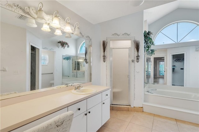 full bathroom featuring tile patterned floors, a shower stall, plenty of natural light, and vaulted ceiling