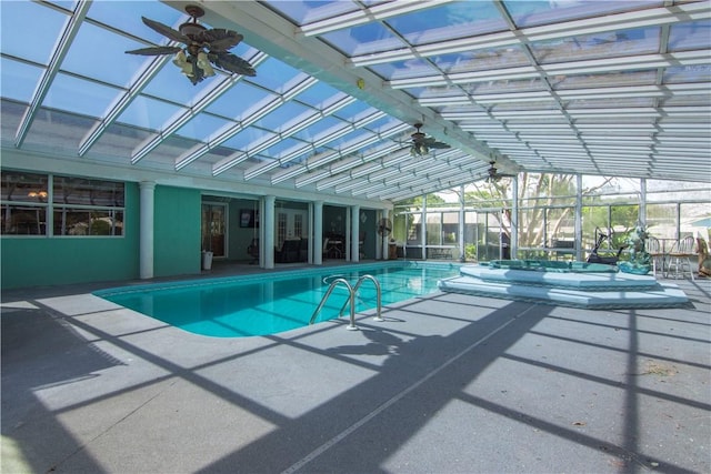 indoor pool featuring a patio area and glass enclosure