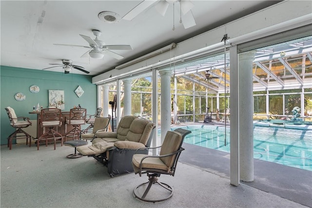 sunroom / solarium featuring a pool and plenty of natural light