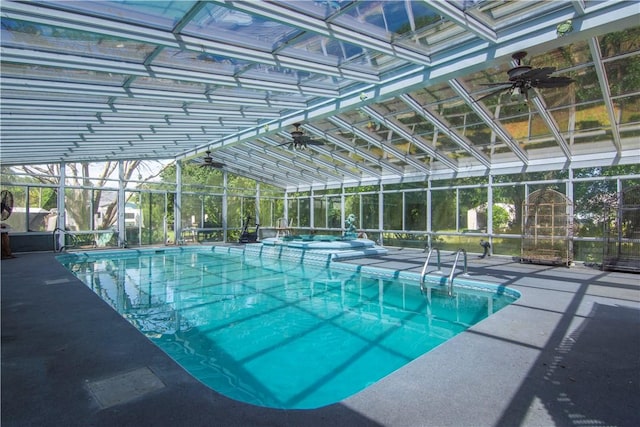 view of pool featuring a pool with connected hot tub, a patio, and a lanai