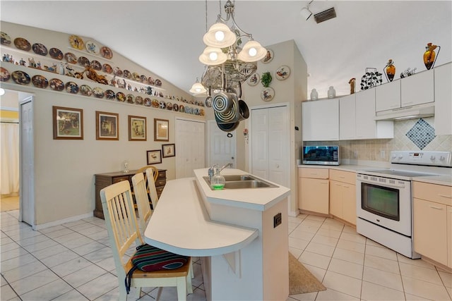kitchen with vaulted ceiling, light tile patterned floors, backsplash, a sink, and white range with electric cooktop