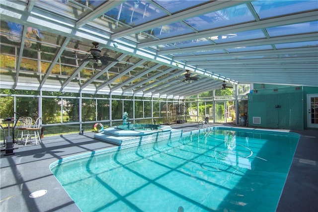 pool featuring glass enclosure and a patio