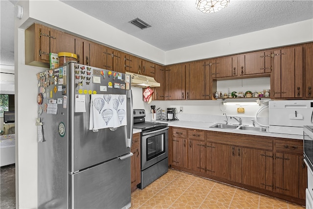 kitchen featuring sink, stainless steel appliances, and a textured ceiling