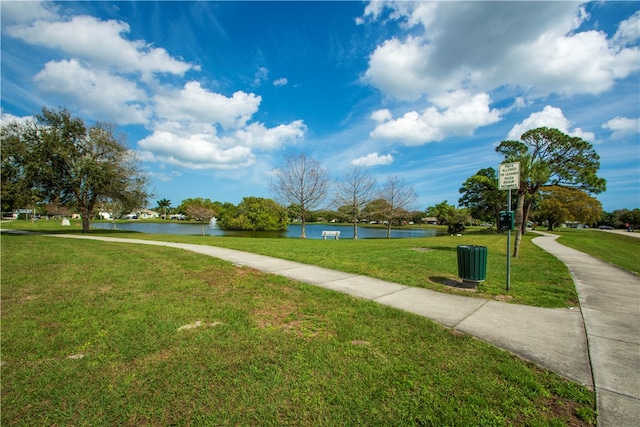 view of community with a yard and a water view