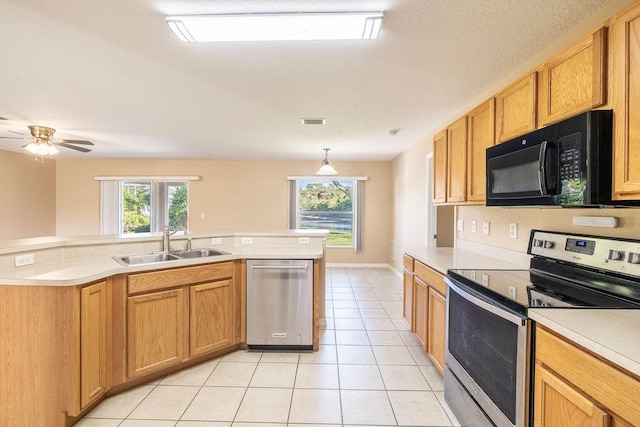 kitchen with stainless steel appliances, ceiling fan, sink, pendant lighting, and light tile patterned flooring