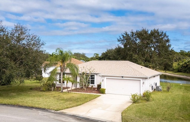 single story home featuring a water view, cooling unit, a garage, and a front yard