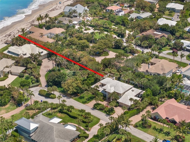 drone / aerial view featuring a beach view and a water view