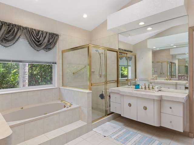 bathroom featuring plus walk in shower, vanity, tile patterned floors, and lofted ceiling