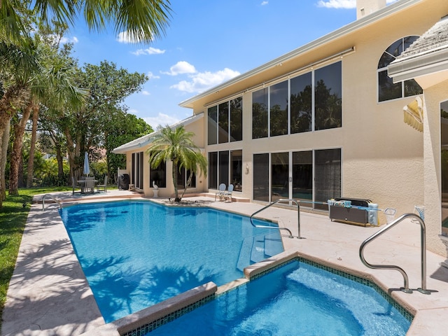 view of pool featuring an in ground hot tub and a patio area