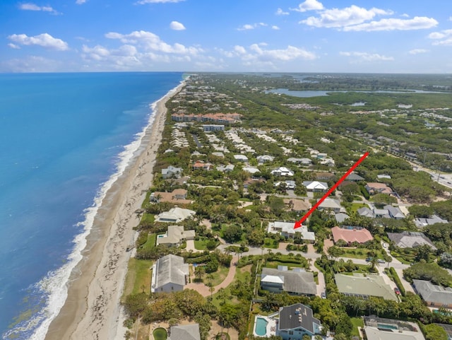 aerial view with a water view and a beach view