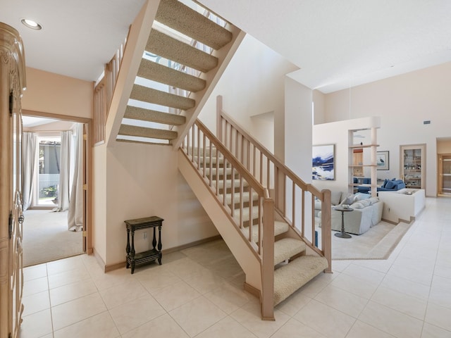 stairway with tile patterned floors