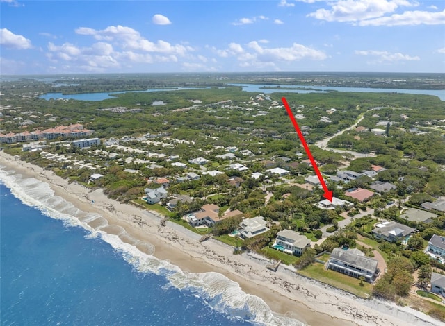 bird's eye view featuring a water view and a beach view