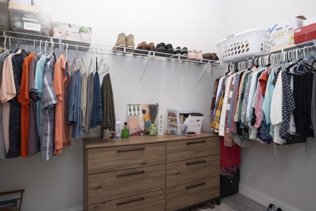 8286 96th Ct, Vero Beach, FL 32967 - walk in closet featuring wood finished floors