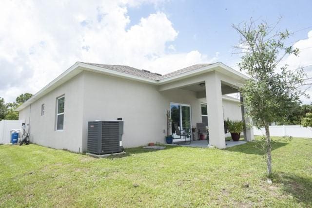 8286 96th Ct, Vero Beach, FL 32967 - back of property featuring central AC, stucco siding, and a patio area