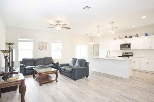 8286 96th Ct, Vero Beach, FL 32967 - living area featuring light wood-type flooring, a ceiling fan, and recessed lighting