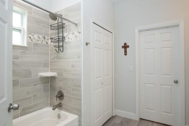 8286 96th Ct, Vero Beach, FL 32967 - full bath with shower / bath combination, baseboards, and wood finished floors