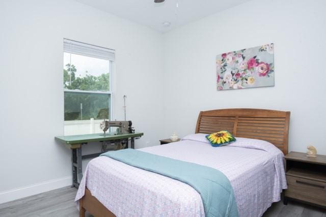 8286 96th Ct, Vero Beach, FL 32967 - bedroom with wood finished floors, baseboards, and a ceiling fan