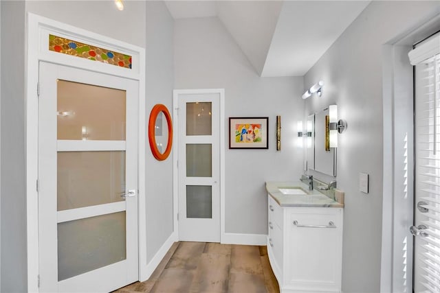 bathroom featuring vanity and vaulted ceiling