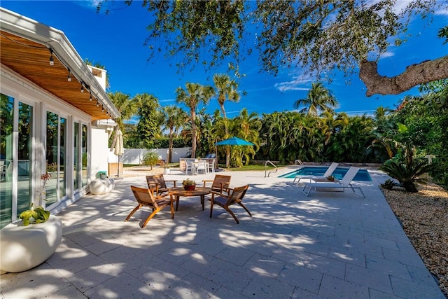 view of patio / terrace featuring a fenced in pool, outdoor dining area, and fence
