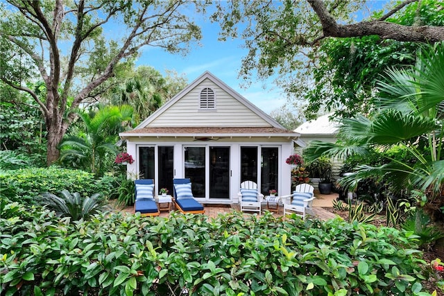 back of property with an outdoor structure