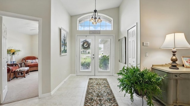 585 Birch Ct, Sebastian, FL 32958 - foyer entrance featuring light tile patterned floors, a notable chandelier, baseboards, french doors, and high vaulted ceiling
