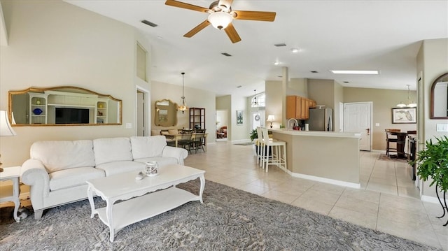 585 Birch Ct, Sebastian, FL 32958 - living room featuring light tile patterned floors, vaulted ceiling, ceiling fan, baseboards, and visible vents