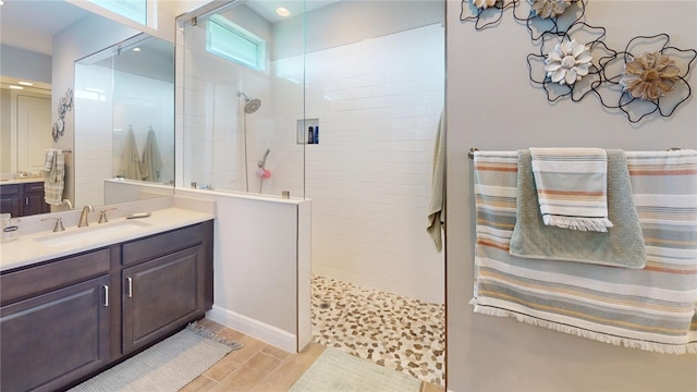 bathroom featuring walk in shower, vanity, and hardwood / wood-style flooring