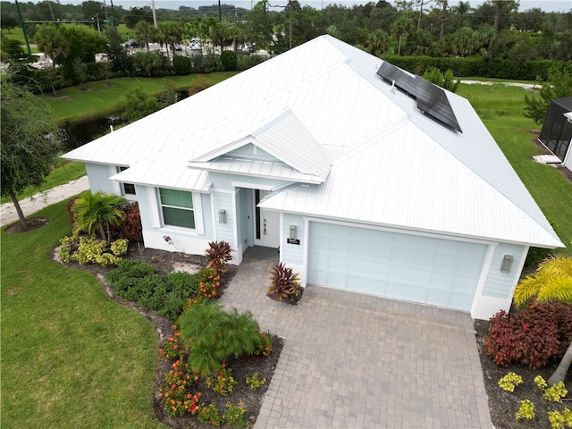 view of front of property with a front lawn and a garage