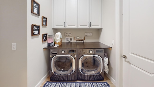 washroom featuring cabinets and independent washer and dryer