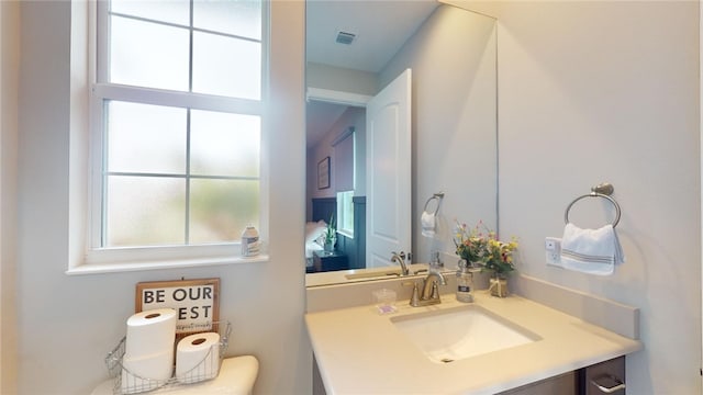 bathroom with vanity and toilet