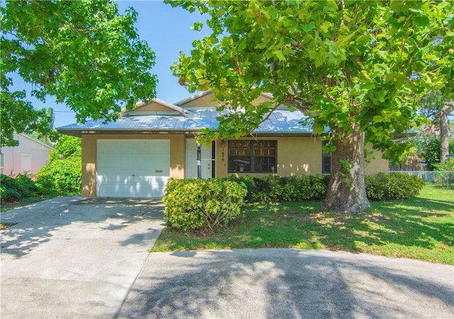 1626 4th Ct, Vero Beach, FL 32960 - view of front of house featuring a garage, stucco siding, and driveway
