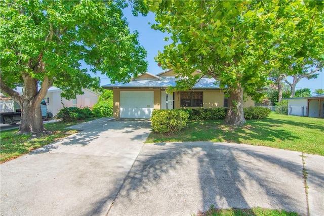 1626 4th Ct, Vero Beach, FL 32960 - view of front of home featuring concrete driveway, an attached garage, and stucco siding
