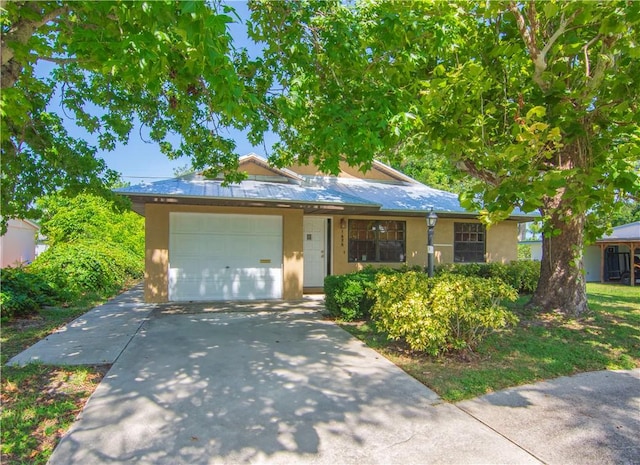 1626 4th Ct, Vero Beach, FL 32960 - view of front facade with driveway, a garage, and stucco siding