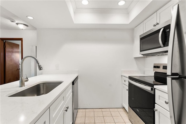 1626 4th Ct, Vero Beach, FL 32960 - kitchen with stainless steel appliances, a raised ceiling, ornamental molding, recessed lighting, and white cabinets