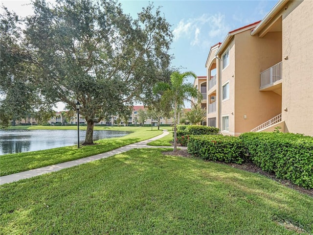 view of property's community featuring a water view and a lawn