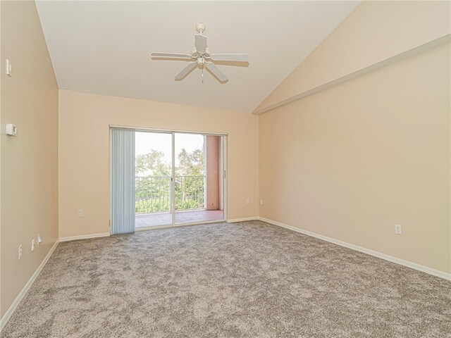 carpeted spare room featuring ceiling fan and lofted ceiling