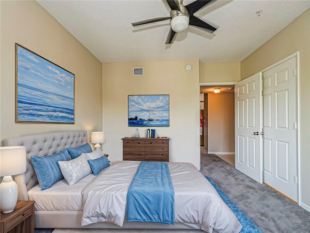 carpeted bedroom with ceiling fan and a closet