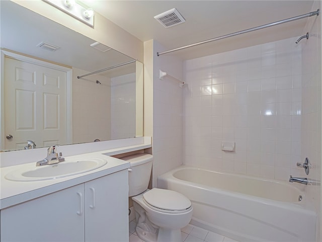 full bathroom featuring tiled shower / bath, tile patterned flooring, vanity, and toilet