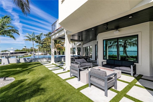 view of patio / terrace featuring ceiling fan and an outdoor living space