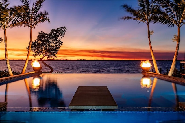 pool at dusk with a water view