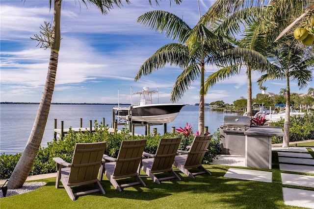 exterior space with a water view and exterior kitchen