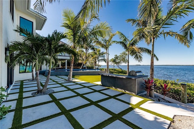 view of patio / terrace featuring a water view, a grill, and area for grilling