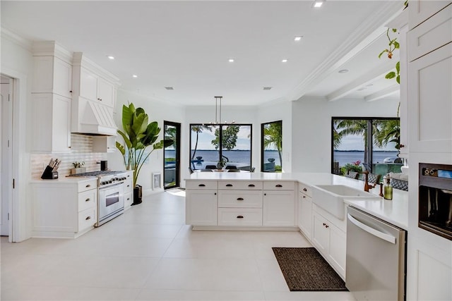 kitchen with appliances with stainless steel finishes, kitchen peninsula, custom range hood, white cabinets, and sink