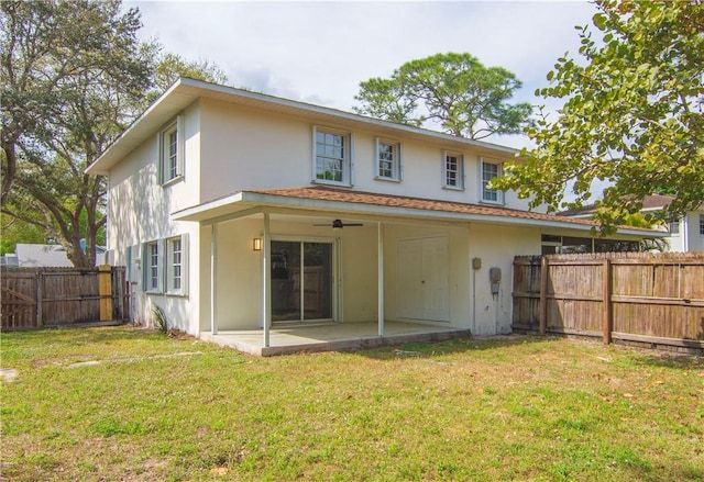 back of property featuring a yard, a fenced backyard, a patio, and stucco siding