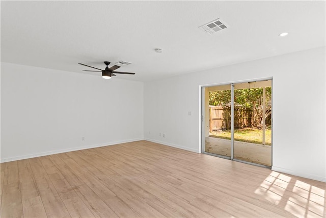 unfurnished room with light wood-type flooring, visible vents, ceiling fan, and baseboards